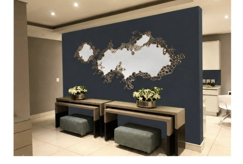 laser cut organic brass mirror on navy feature wall in corporate reception, wall design and installation